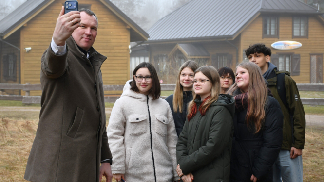 Priekšsēdētājs taisa fotogrāfiju ar jauniešiem